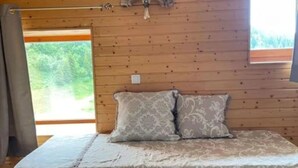 A wooden-paneled room with a bed, a window, and a ceiling fan. - Duplex Apartment 'Les 7 Marmottes', 306, Mountain View and Balcony (Chamrousse)