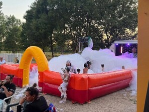 Ein aufblasbarer Wasserpark mit Rutsche und einem gelben Bogen.