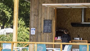 A food truck with a chalkboard menu listing items like crepe and gratin. There are outdoor seating chairs and a person standing behind the counter. - Camping 3 étoiles - ccbfigd (Ombrée d'Anjou)