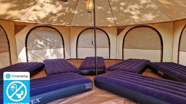 A tent with multiple sleeping areas, each with a mattress and a canopy. - Camping 3 étoiles - Piscine  - ccbfbcd (Mondragon)