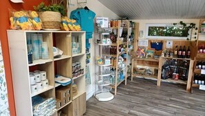 Una botiga elegant amb prestatgeries de fusta, una varietat de productes i una petita planta.