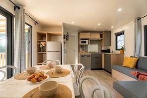 Ein modernes Apartment mit Essbereich, Küchenzeile und Wohnbereich.