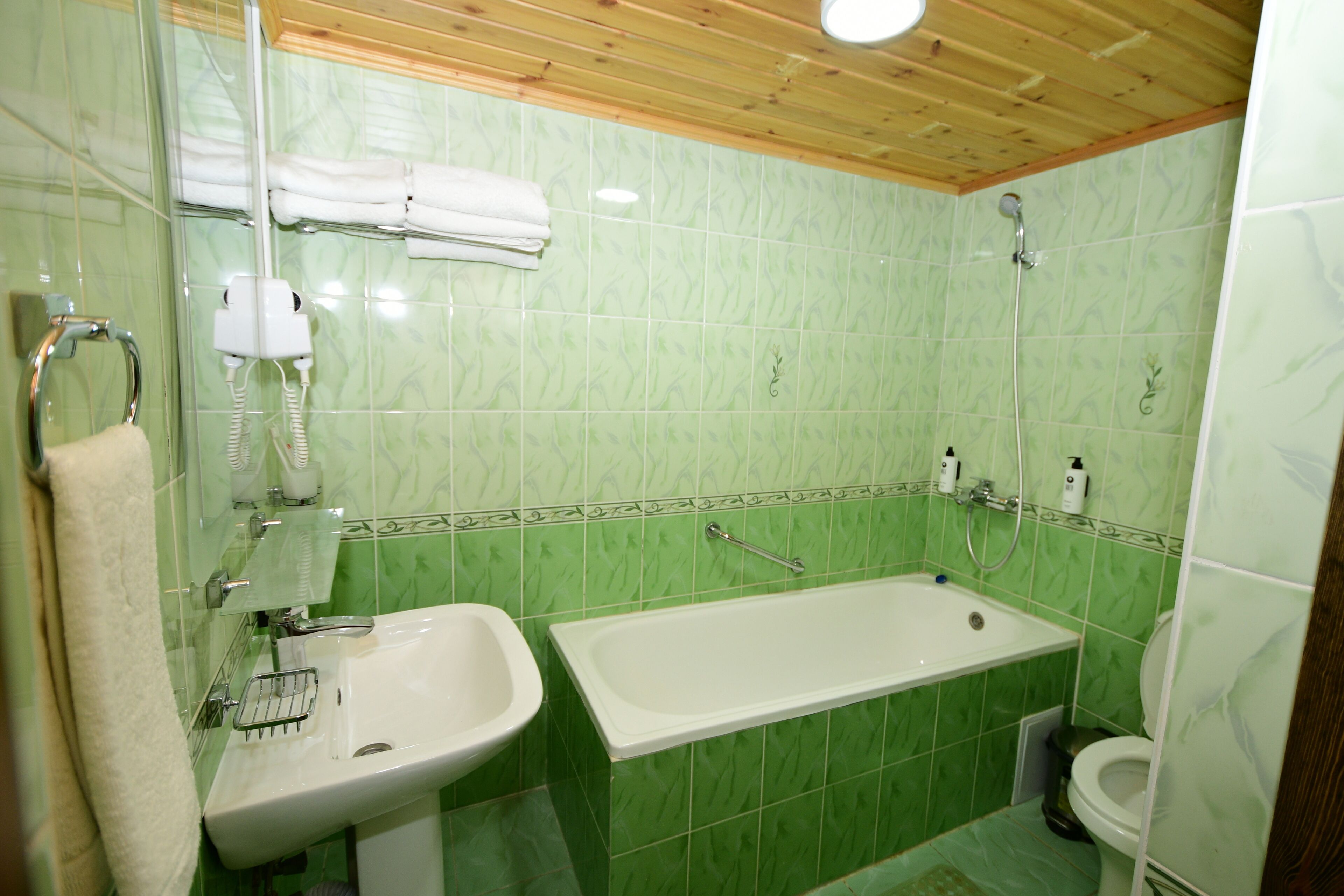 A bathroom with a sink, bathtub, and toilet.
