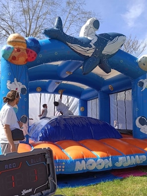 An inflatable moon jump with astronaut and space-themed designs.