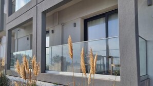 A modern building with large windows and a balcony. - Maritime Suites (Hersonissos)