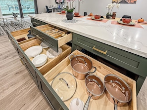 A kitchen with open drawers containing plates, bowls, and pots. - Mountain Views and Breeze Spacious Home with In law Suite 20 mins Ventura  Beach (Simi Valley)