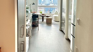 A modern kitchen with a city view, a dining area with a table and chairs, and a built-in oven. - Cozy 1-bedroom apartment with AC in vibrant Seattle neighborhood (Seattle)