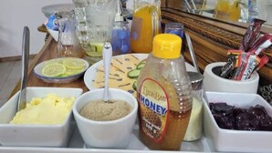 A breakfast buffet with various food items and condiments.