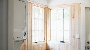 A compact room with wooden walls, a built-in bench, and a window. - The Doctor's Cottage -- 1 mile from Prisma Hospital, 2 miles from Downtown GVL (Greenville)