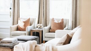 A living room with two armchairs, a small wooden stool, and a couch. - The Doctor's Cottage -- 1 mile from Prisma Hospital, 2 miles from Downtown GVL (Greenville)