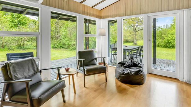 A spacious room with large windows, a wooden ceiling, and a view of the outdoors. - "Julika" - 560m from the sea by Interhome (Sæby)