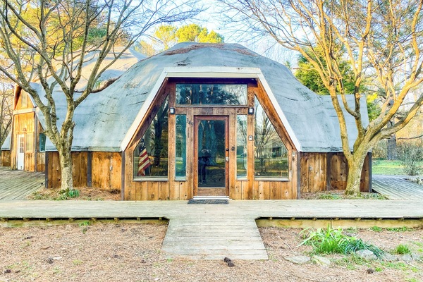Welcome to the Dome House on Bell! This unique, dome-style exterior is set among beautiful trees and natural surroundings, creating a quiet and relaxing retreat.