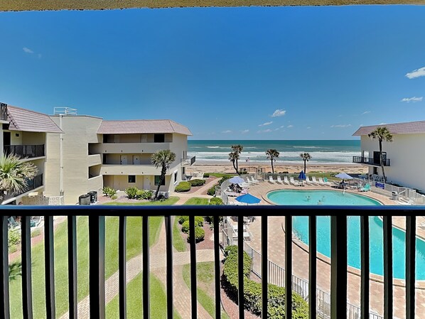 A resort with a pool, beach view, and multiple-story buildings. - Bent Palm 302 (Ormond Beach)