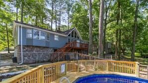 A house with a stone foundation, a wooden deck, and a swimming pool. - Lake View Landing | Pool/Groups/Nature/Games (Birmingham)