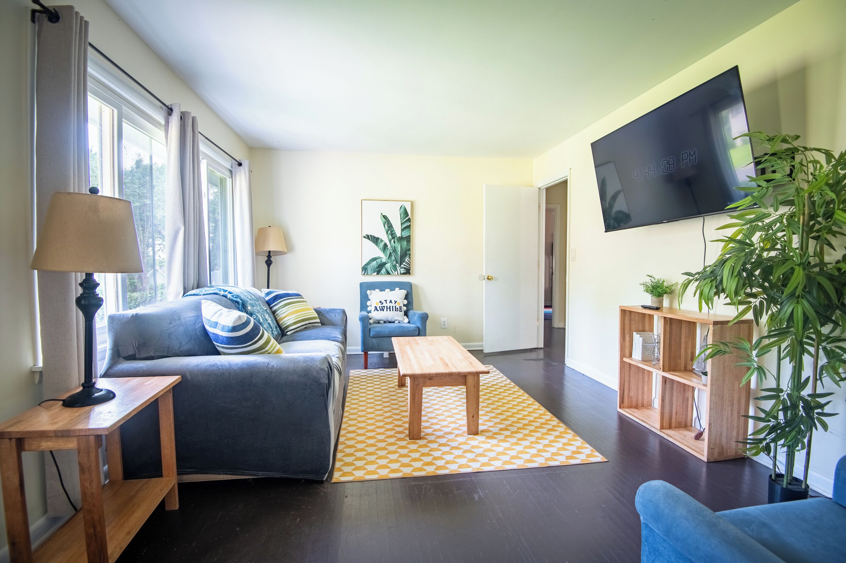A living room with a sofa, a coffee table, a TV, and a bookshelf.