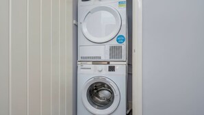 A front view of a stacked washer and dryer unit. - London Flat With Private Entrance (London)