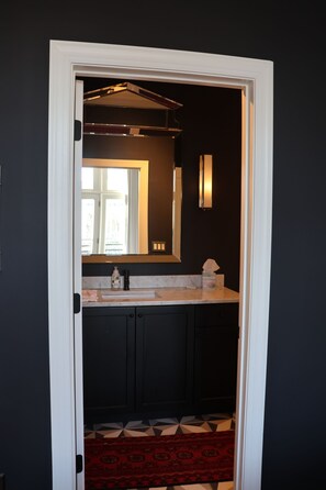 Ein Badezimmer mit Spiegel, Waschbecken und Toilette.