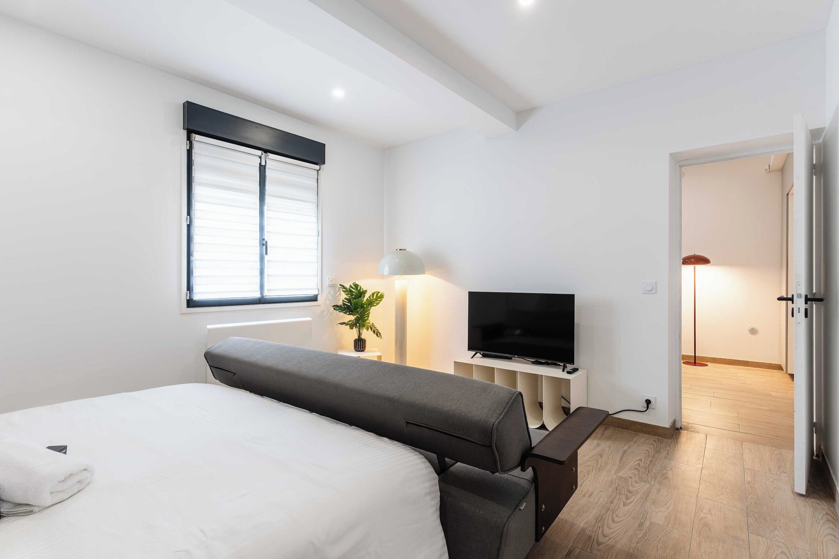Laptop workspace, iron/ironing board, bed sheets