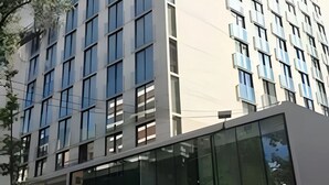 A modern building with large windows and a flat facade. - Dummy Malaga (Santiago)