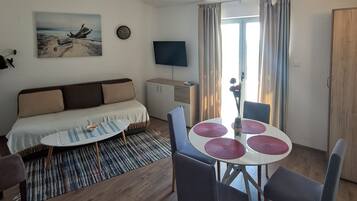 Club Apartment | Living area | 32-inch LCD TV with satellite channels, Netflix, streaming services