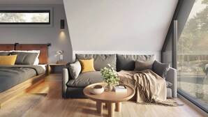 A modern bedroom with a bed, sofa, and a round wooden table with a vase and book. - “More than a stay-84 Ranch is a connection to the land, the animals, and what truly matters.” (Pagosa Springs)