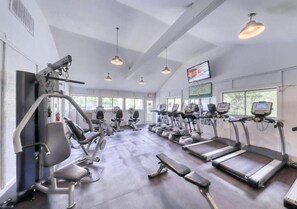 A gym with treadmills, elliptical machines, and weight benches. - 3-bed 3 bath ocean front apt, two balconies. Pool, courts, grills, beach access. (Hilton Head Island)