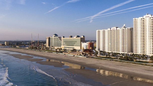 A beachfront hotel with multiple high-rise buildings, a sandy beach, and a clear sky. - Spacious 3-bedroom Wyndham condo on the Atlantic  inDaytona Beach. (Daytona Beach)