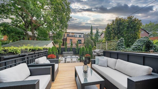 A rooftop patio with outdoor furniture, a grill, and a view of the neighborhood. - Rare Yorkville Detached House with Parking and Hot Tub (Toronto)
