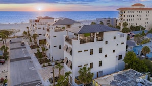 A beachfront hotel with multiple-story buildings, balconies, and a view of the ocean. - Direct Beach Access, Panoramic Rooftop, Pool/Spa (Clearwater)