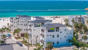 A beachfront hotel with multiple-story buildings, balconies, and a view of the beach and ocean. - Direct Beach Access, Panoramic Rooftop, Pool/Spa (Clearwater)