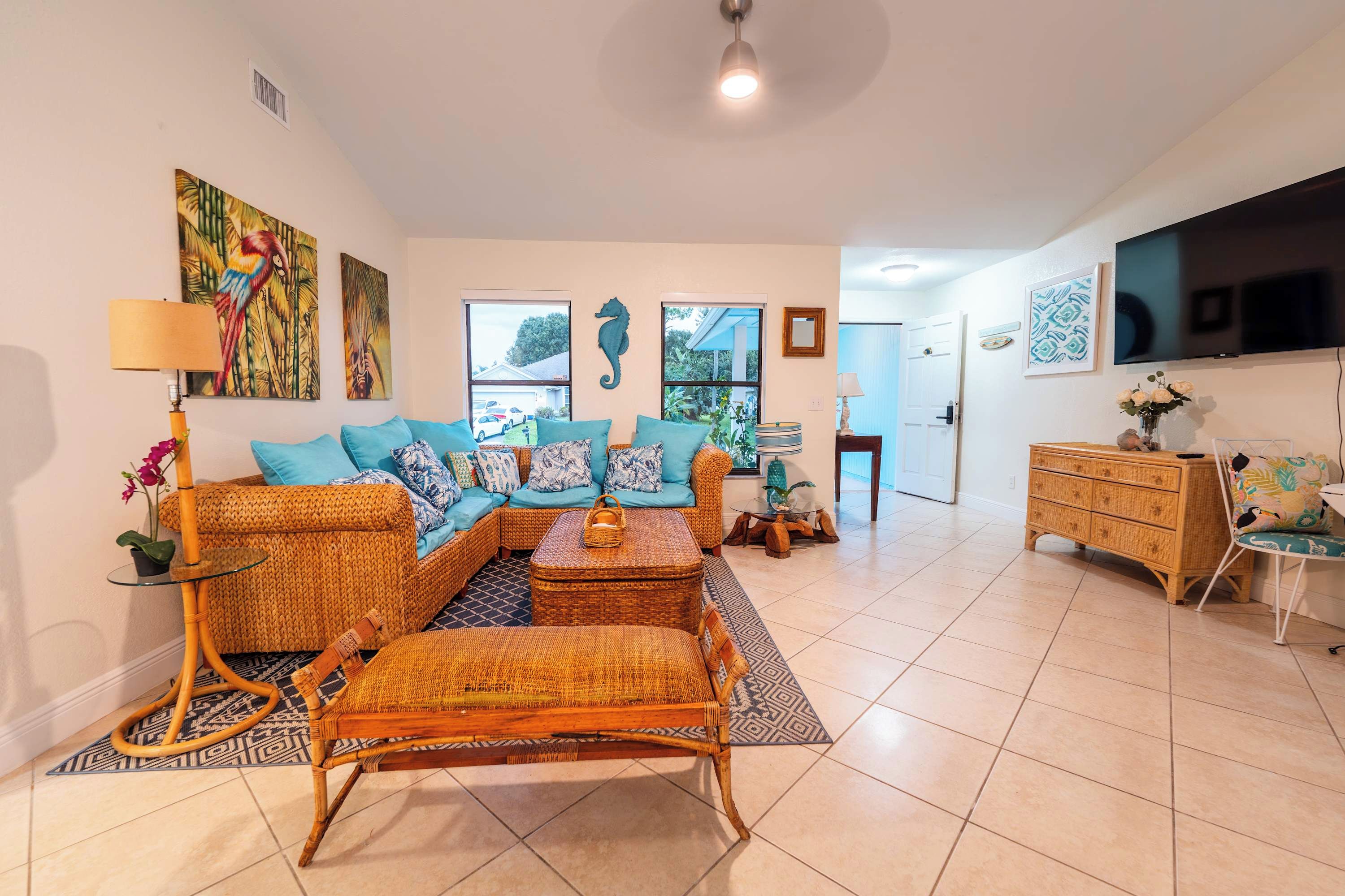 A living room with a sofa, coffee table, and a television.