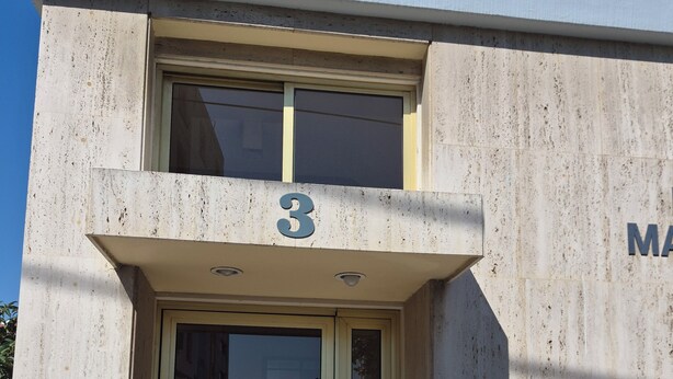 A building entrance with a glass door, a 'no entry' sign, and a number '3' above the door. - Urban Nest Central Nicosia Spacious 2BR Apartment (Nicosia)