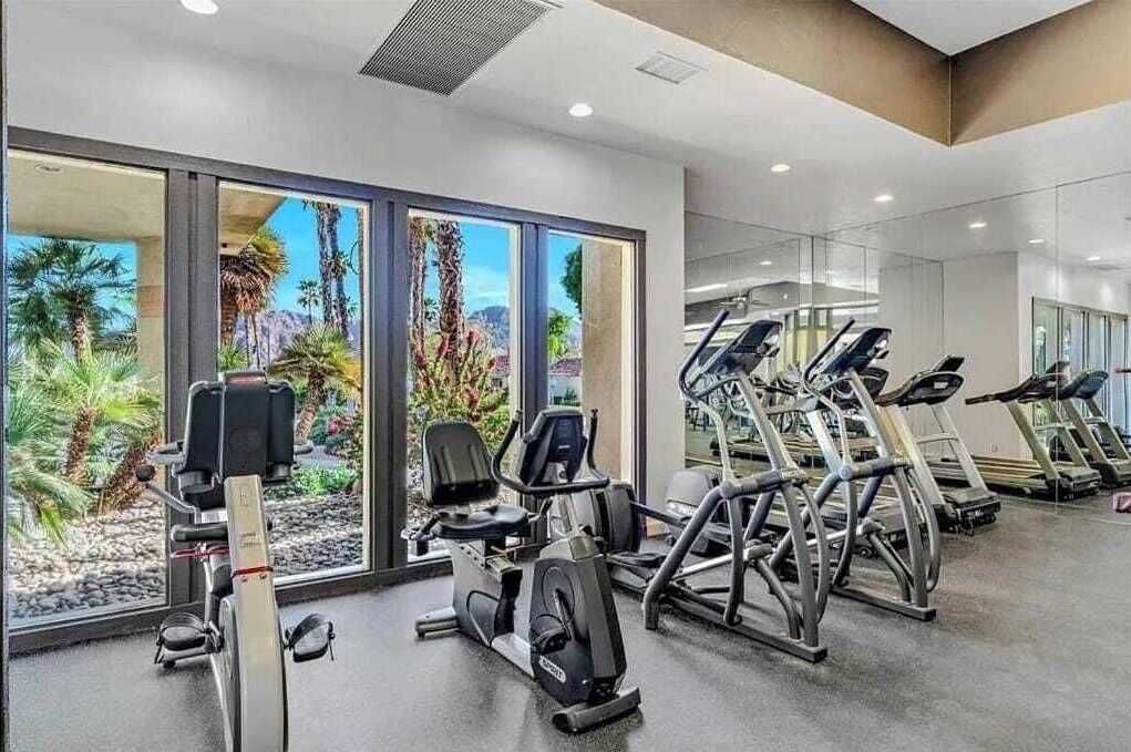 A gym with stationary bikes, treadmills, and exercise equipment.
