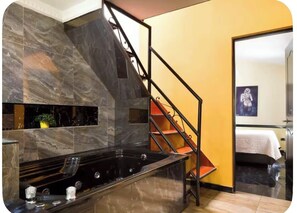 A modern kitchen with a black countertop, a built-in stove, and a marble backsplash. - 66 Beautiful apartment in poblado near Éxito and metro station (Medellín)