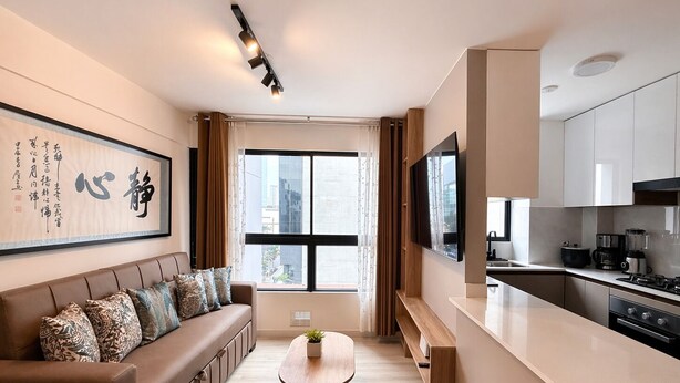 A modern living room with a sofa, a coffee table, and a TV. - Elegant Apartment Modern Design - 1006 (Lima)