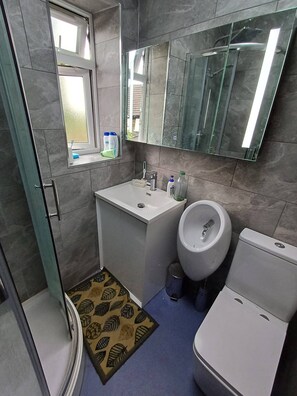 A compact bathroom with a toilet, bidet, sink, and a mirror above the sink. - Room-cosy Single Room Near CBS Arena and (Coventry)
