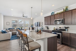 A modern kitchen with a central island, stainless steel appliances, and wooden cabinetry. - Stillwater Retreat - Beautiful 3 bedroom townhouse in belgrade (Belgrade)