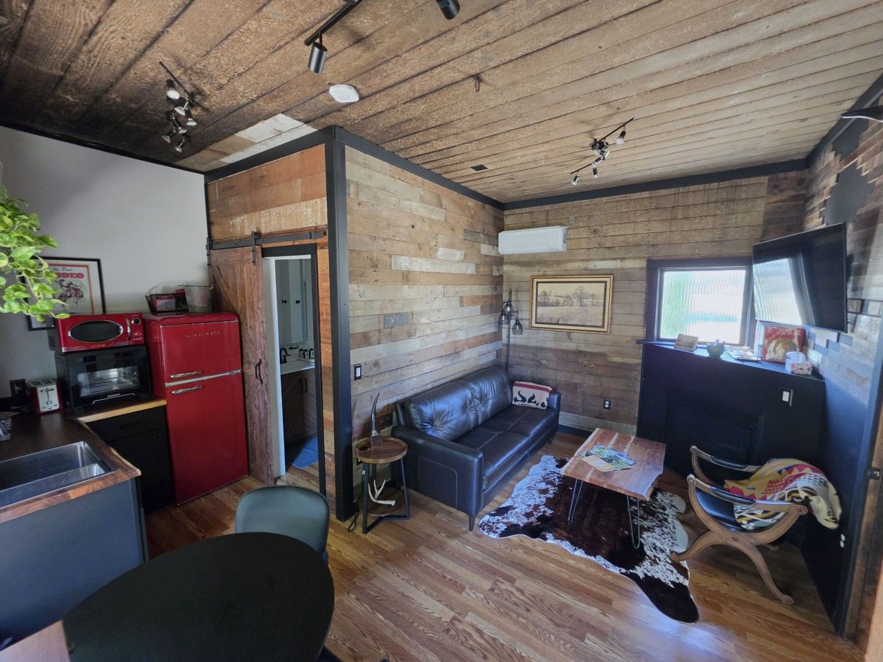 Welcome to Villa Brut! Reclaimed wood, a cherry-red fridge and a leather sofa with your name on it
