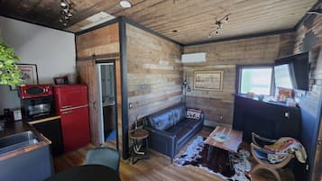 Welcome to Villa Brut! Reclaimed wood, a cherry-red fridge and a leather sofa with your name on it
