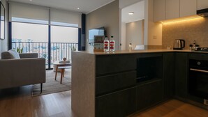 A modern kitchen with a dining area, large windows, and a view of the city. - w* | Cityview 2BR w/ Balcony in Miraflores (Miraflores)