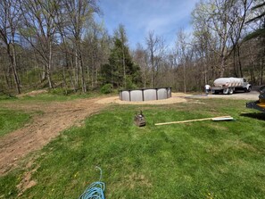 A backyard with a shed, a gravel area, and a truck.