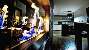 A modern kitchen with a built-in stove and a visible dining area. - Luxury Wellness by Interhome (Rokytnice nad Jizerou)