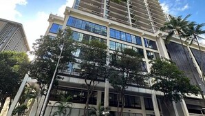 A high-rise building with multiple floors, large windows, and a modern architectural design. - Downtown Honolulu Condo | AC • W/D • Parking (Honolulu)