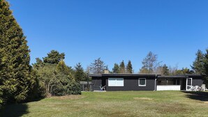 A two-story house with a front porch, a small deck, and a garage.