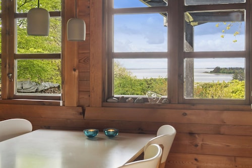 Nature holiday in peaceful log cabin by water