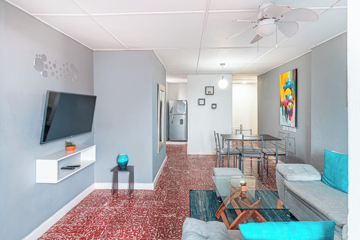 Appartement, 2 chambres, vue ville | Coin séjour | Télévision à écran plat de 42 pouces avec chaînes par satellite, livres