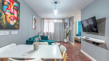 Apartment, 2 Bedrooms, Balcony, City View | Living area | 42-inch flat-screen TV with satellite channels, books