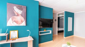 Apartment, 2 Bedrooms, City View | Desk, laptop workspace, blackout drapes, iron/ironing board