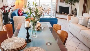 A modern living room with a sofa, coffee table, and decorative items. - Preveza Stay Near the Harbor (Preveza)