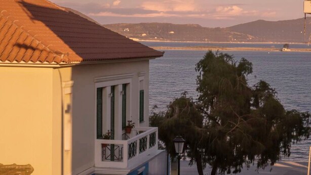 A coastal building with a balcony, a stop sign, and a view of the sea. - Preveza Stay Near the Harbor (Preveza)